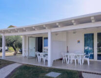 furniture, grass, chair, table, sky, building, outdoor, kitchen & dining room table, coffee table, house, home